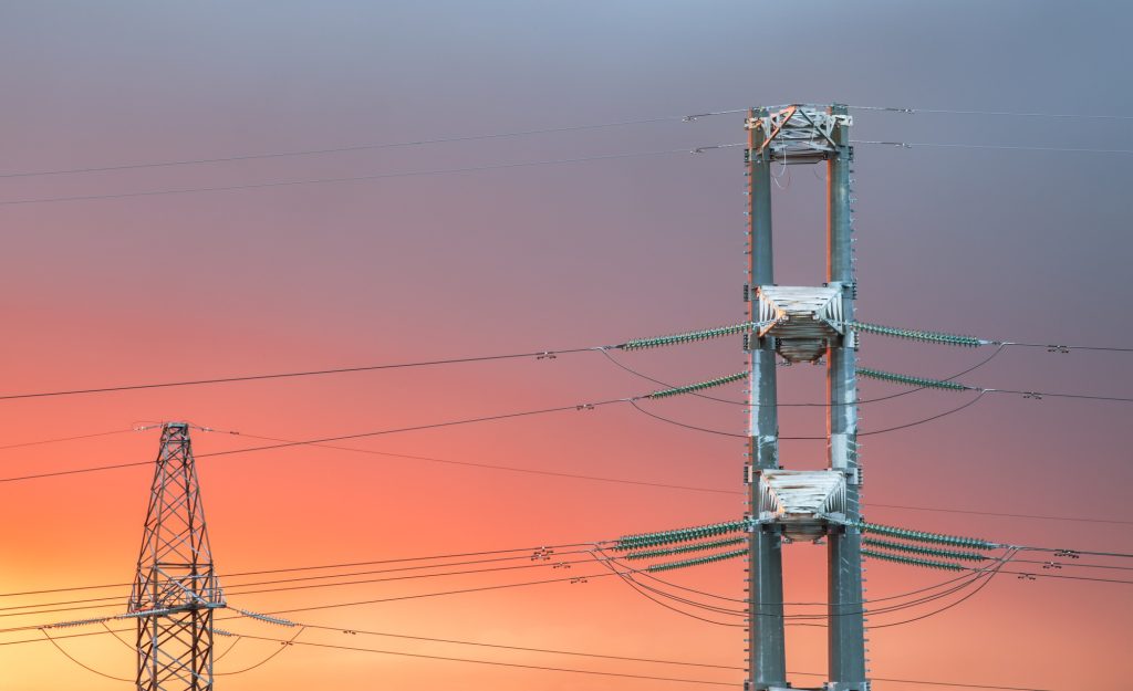 High voltage power transmission line on sunset